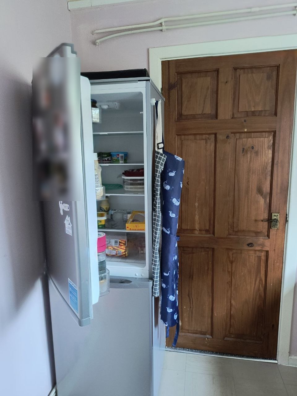 After: the fridge-freezer door opening back against the wall, with the shelves in view and the inside easy to reach